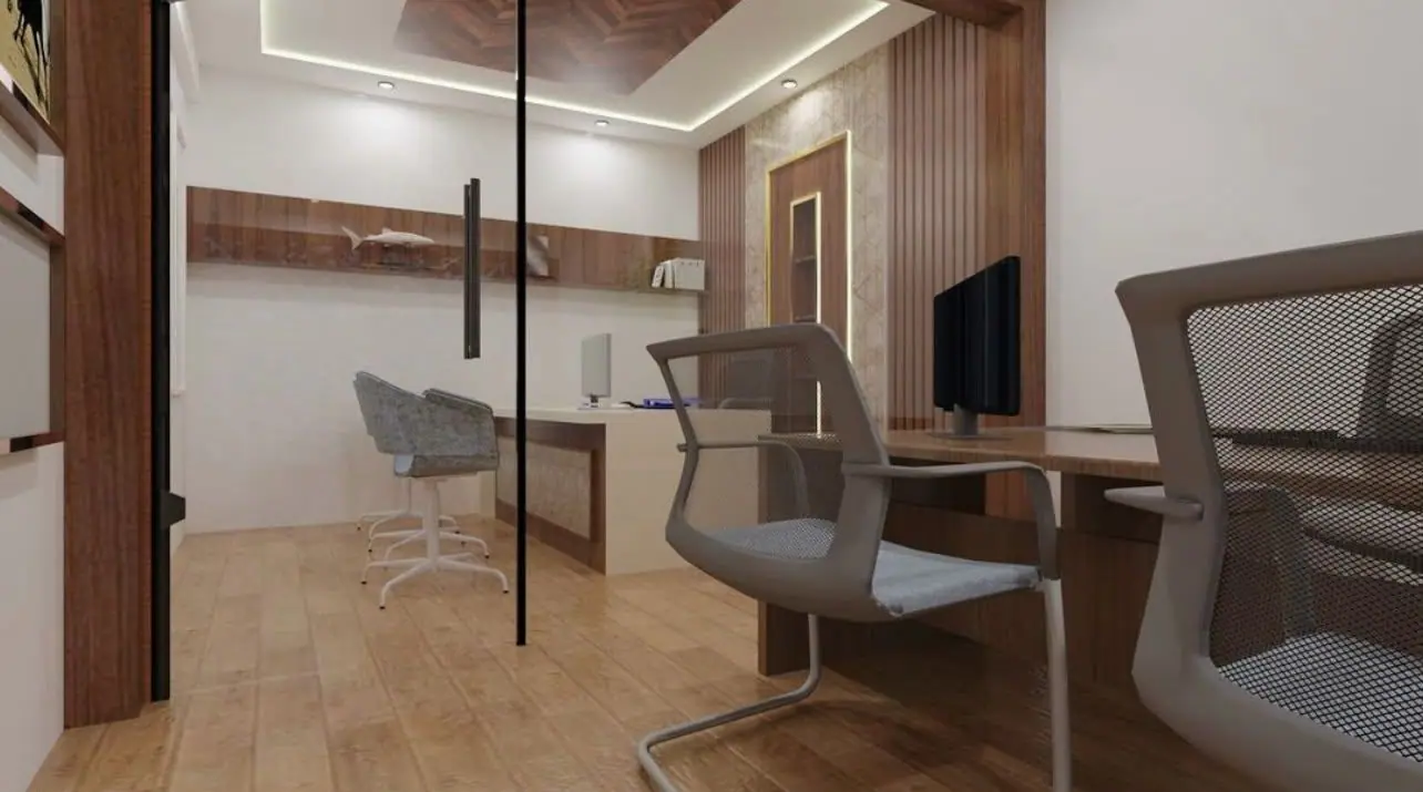Office cabin seen through a glass partition, with a TV unit and a meeting desk