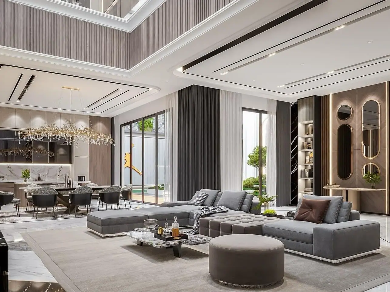 Double-height living room design with a grey sectional, layered ceiling and an open dining area